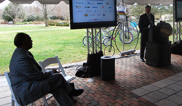 Richmond Mayor Dwight Jones watches Gov. Bob McDonnell give an update on the world cycling championship fundraising progress. (Photo by Lena Price)