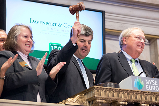 Lee Chapman rings the closing bell of the New York Stock Exchange on April 8 beside Coleman Wortham. (Courtesy of Davenport & Co.)