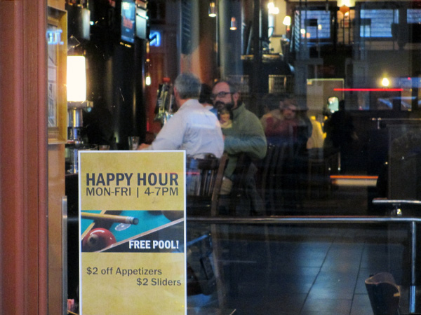 Popkin Tavern at 123 W. Broad St. advertises its happy hour. (Photo by Michael Thompson)