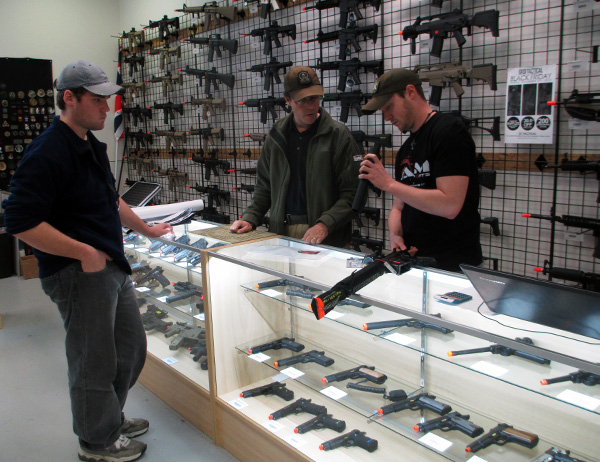 GI Tactical assistant store manager Ed Gatti, center, and in-house technician Zach Litten. (Photos by Burl Rolett)
