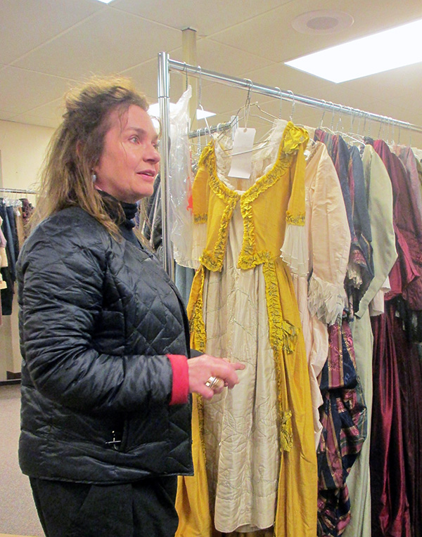 Costume designer Donna Zakowska shows off outfits that arrived recently from England.