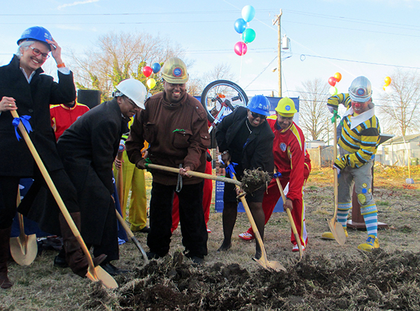 Local Habitat chief executive Jane Helfrich, aft left, and Spence Daniels, center, help break ground on North 35th Street. (Photos by Brandy Brubaker)
