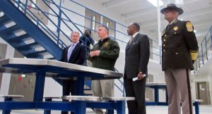 Mayor Dwight Jones, second from right, and other officials give the media a tour of the new city jail Wednesday. (Photo by Brandy Brubaker.) 