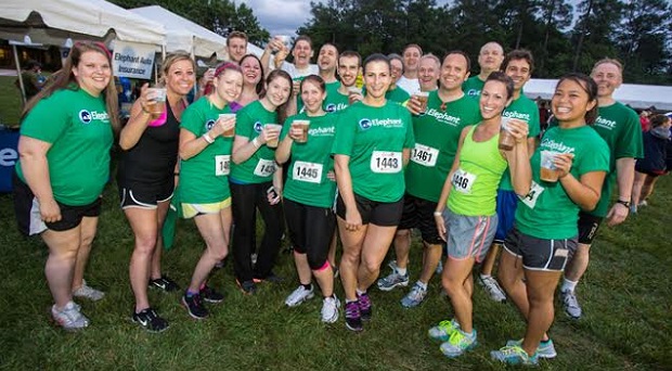 Participants celebrate after finishing the 2013 Sports Backers Corporate  4-Miler race. Photo courtesy of Sports Backers.