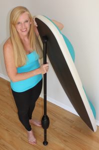 Angie Hardison with a yoga paddle board. 