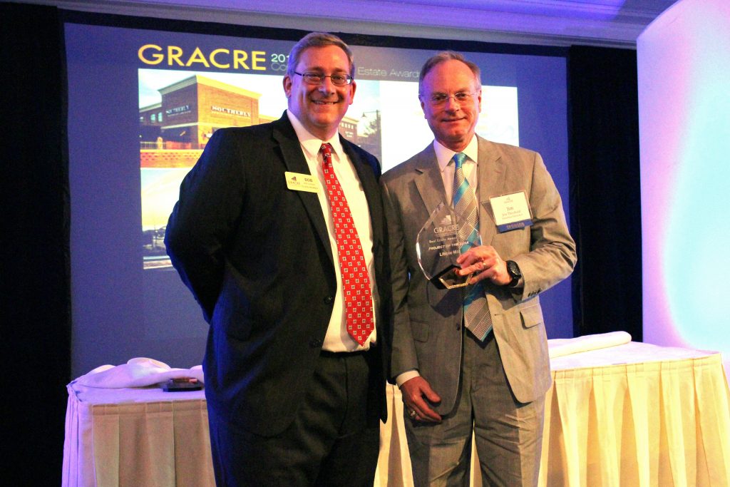 GRACRE Director Bob Hughes (left) gives developer Jim Theobald an award for his Libbie Mill project. Photos by Katie Demeria.