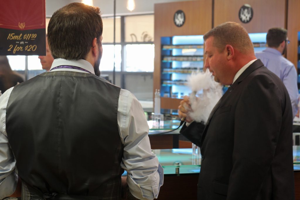 A visitor tests out an e-cigarette at Avail's opening event on Wednesday. Photos by Michael Thompson.