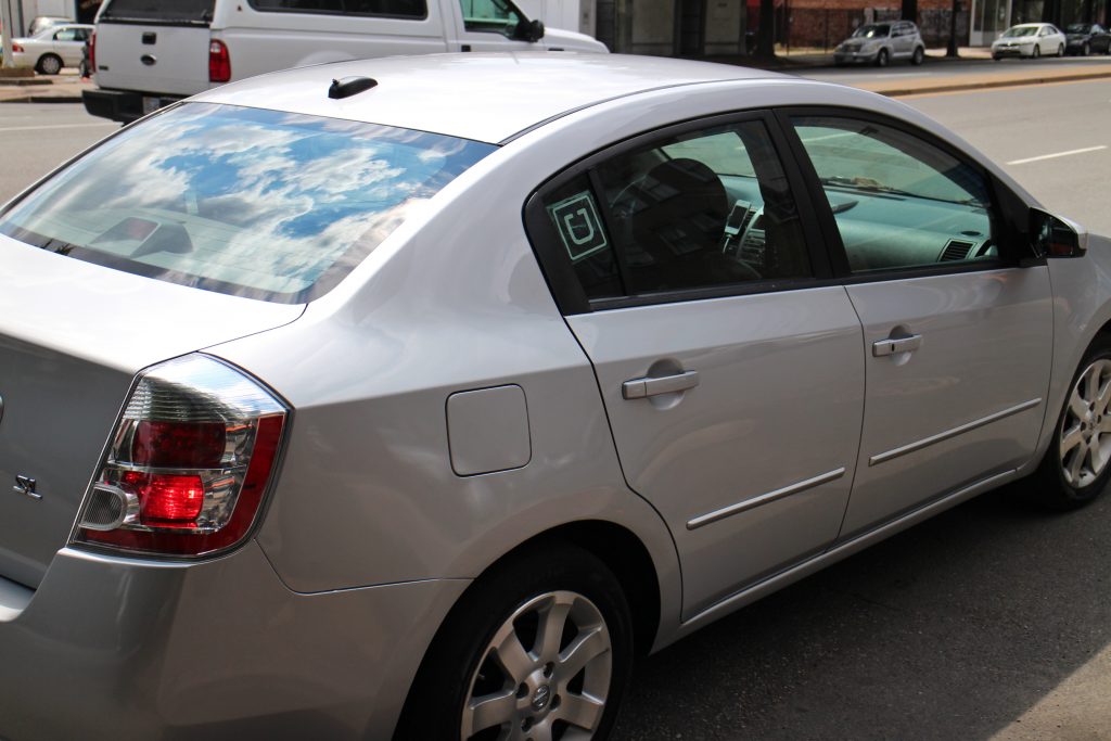Uber drivers use their personal cars - marked with a small window sticker . Photos by Michael Thompson.