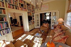 The home's family room has built-in bookshelves to the ceiling and French doors. 