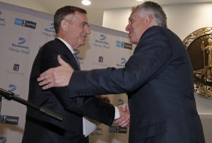 Thomas Farrell, left, Chairman, President and CEO of Dominion, shakes hands with Virginia Gov. Terry McAuliffe, after Farrell announced that the Virginia Values Veterans, was selected as the recipient of the proceeds from the Dominion Charity Classic. The V3 program is designed to ease the transition of military veterans to civilian careers. Dominion is the title sponsor of the PGA Champions tournament. (Dominion Photo)