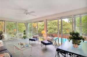 The home includes a sun room and in-ground pool. 