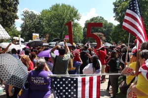 Fight for $15 supporters congregated in Monroe Park before marching up Monument.