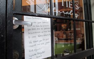 A note on the door tells customers the business is closed. (Jonathan Spiers)