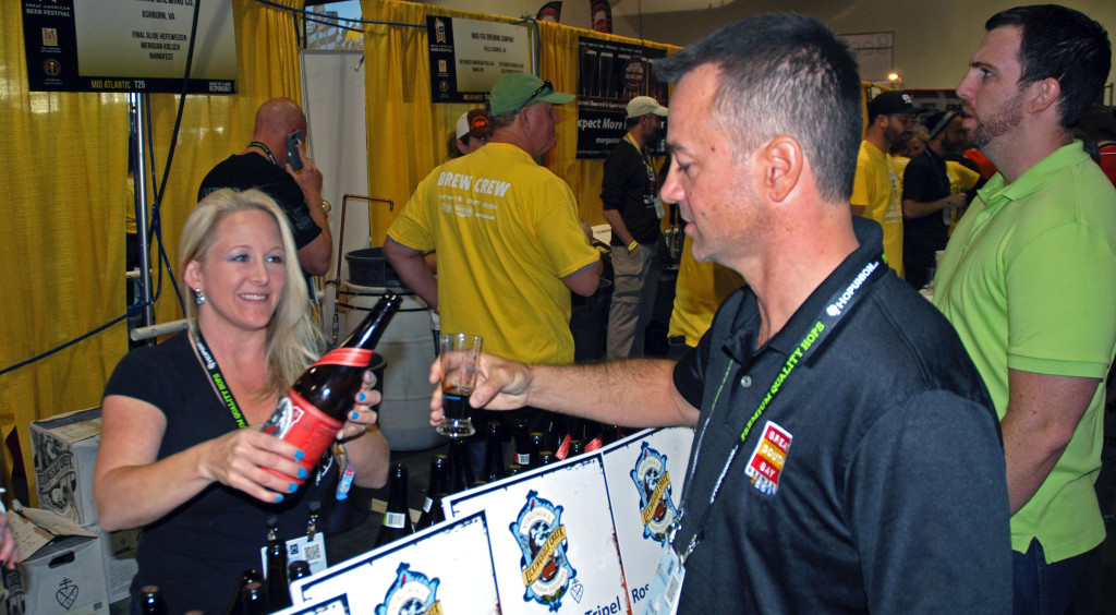 Lisa Pumphrey of Lickinghole Creek Craft Brewery pours a sample of Enlightened Despot, a barrel-aged Russian imperial stout, on Thursday, Oct. 2, 2014, at the Great American Beer Festival in Denver, Colorado. Photo by Michael Felberbaum.