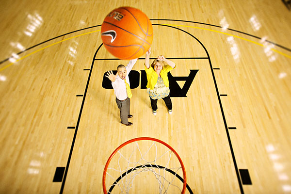 VCU men's basketball coach Shaka Smart gives Health Diagnostics Laboratory chief executive Tonya Mallory a few pointers. (Photos courtesy of  Health Diagnostics Laboratory)