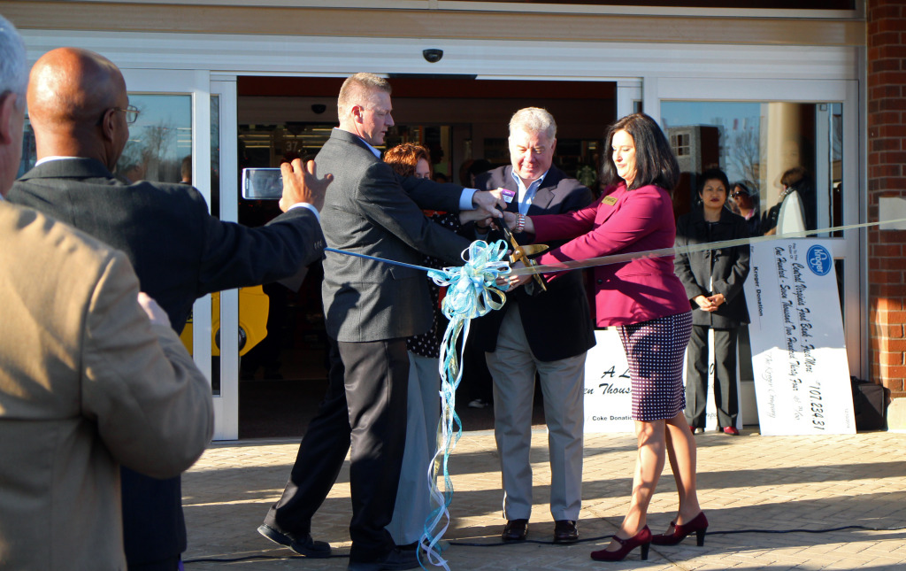 From left: General Manager Stan Rewerts, FeedMore CEO Doug Pick and Sherry Hedrick, director of customer development for Coca-Cola, cut the ribbon on the newest Kroger. Photo by Katie Demeria.